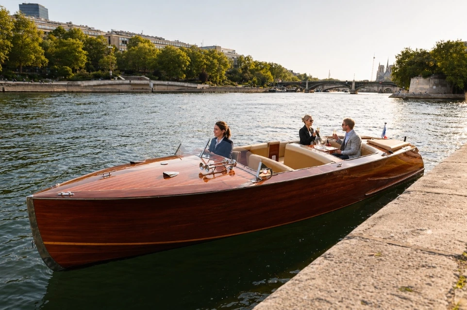 Felicità wooden private boat on the Seine River in Paris with guests on board